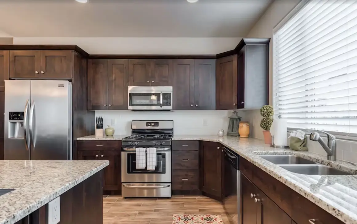 Kitchen with a stainless gas range, microwave and side-by-side fridge
