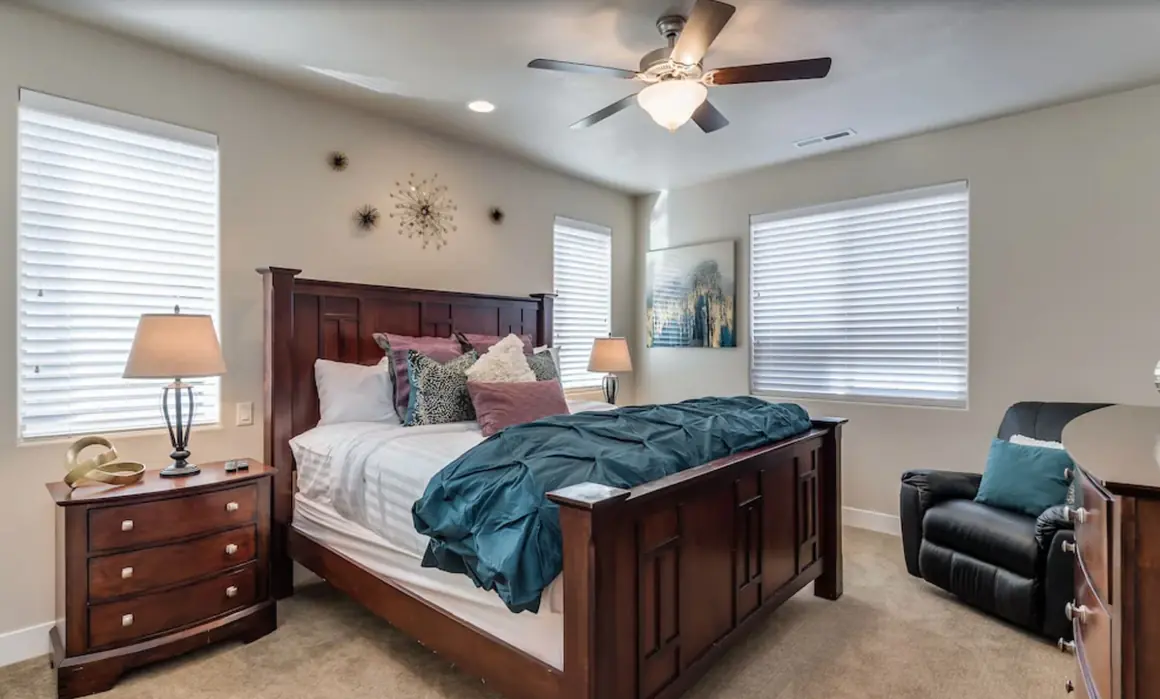 Primary bedroom with a dark wood king bed and teal bedding