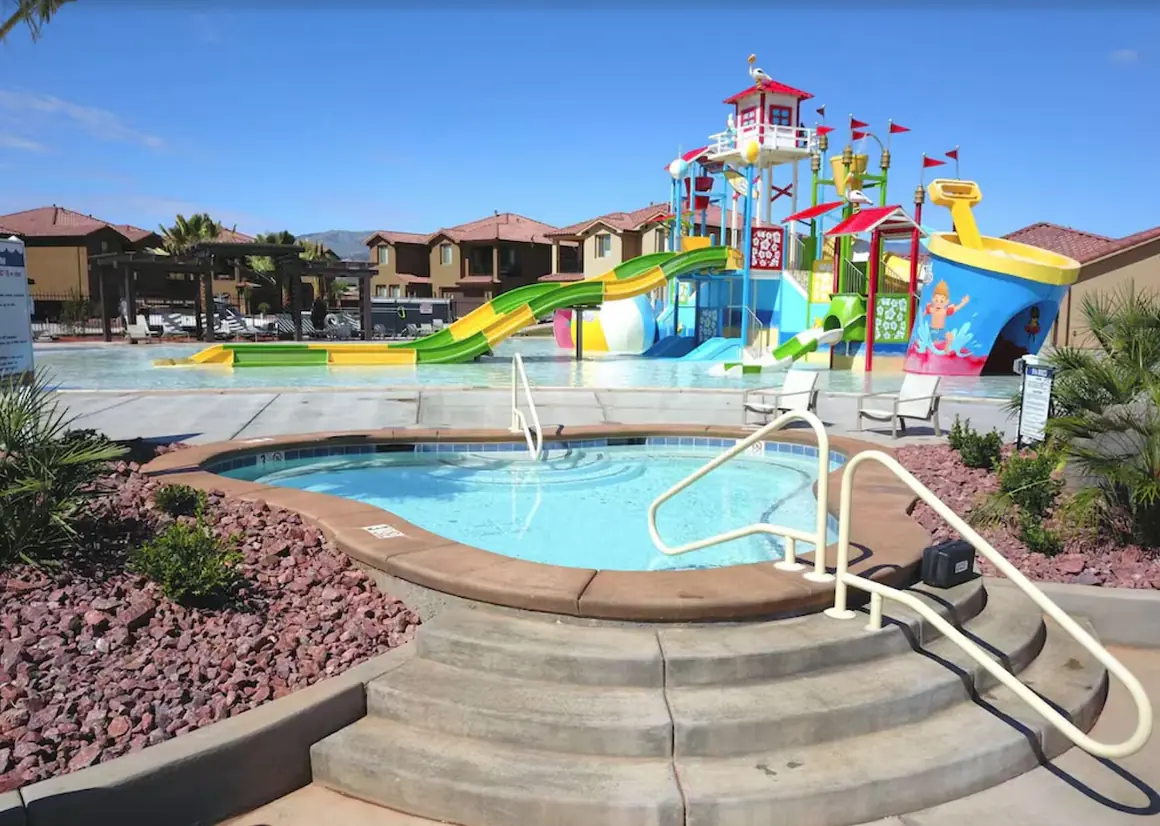 Large hot tub with the splash pad and slides behind it