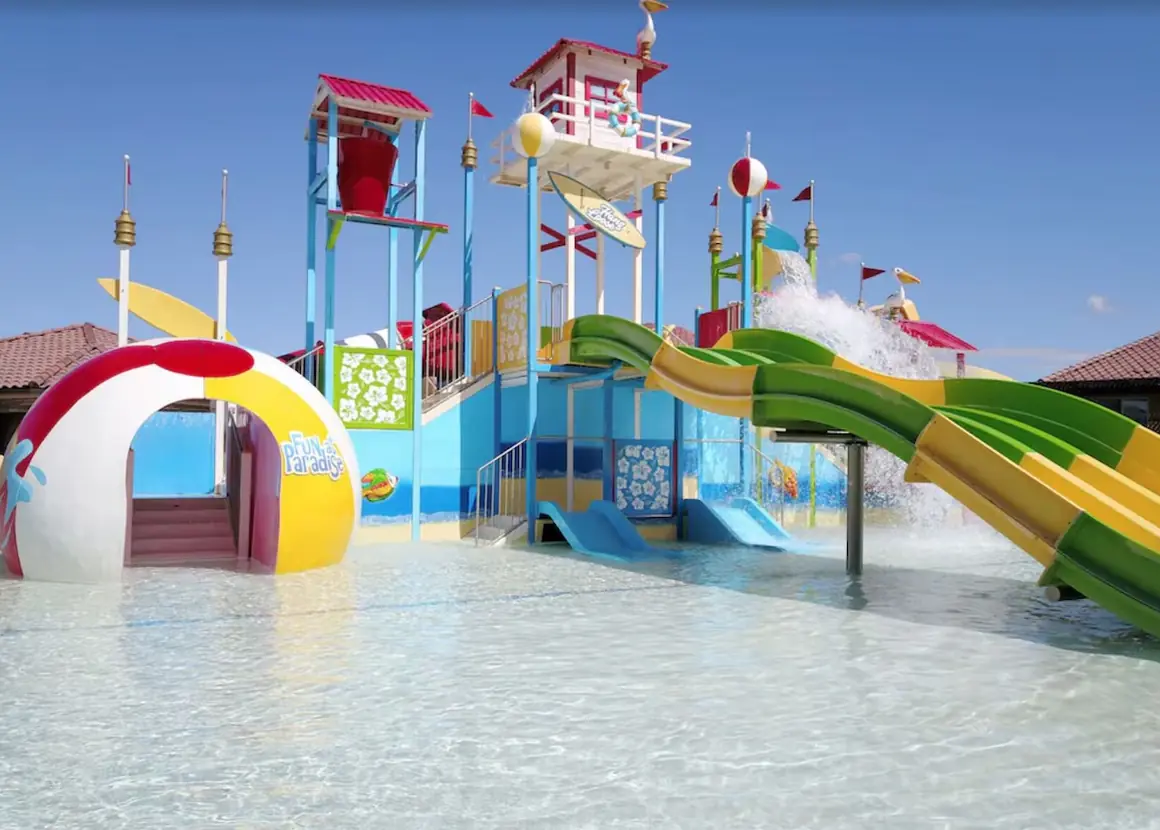 Colorful water park play structure with twisting slides